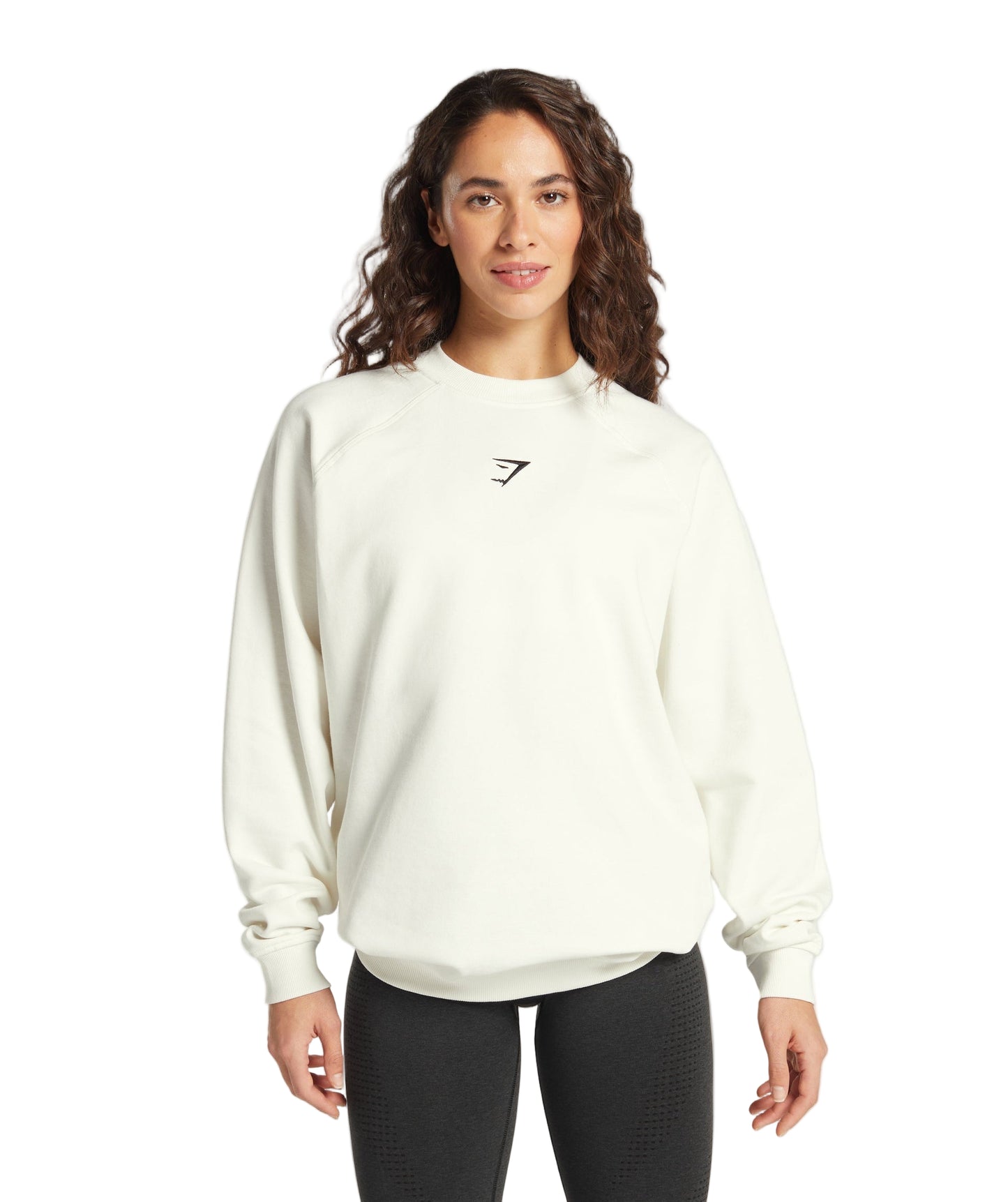 Woman wearing a white sweatshirt with a logo on a light gray background